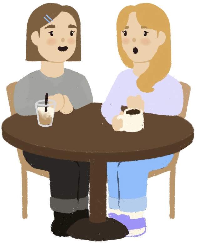 two girls sitting at a table with coffee